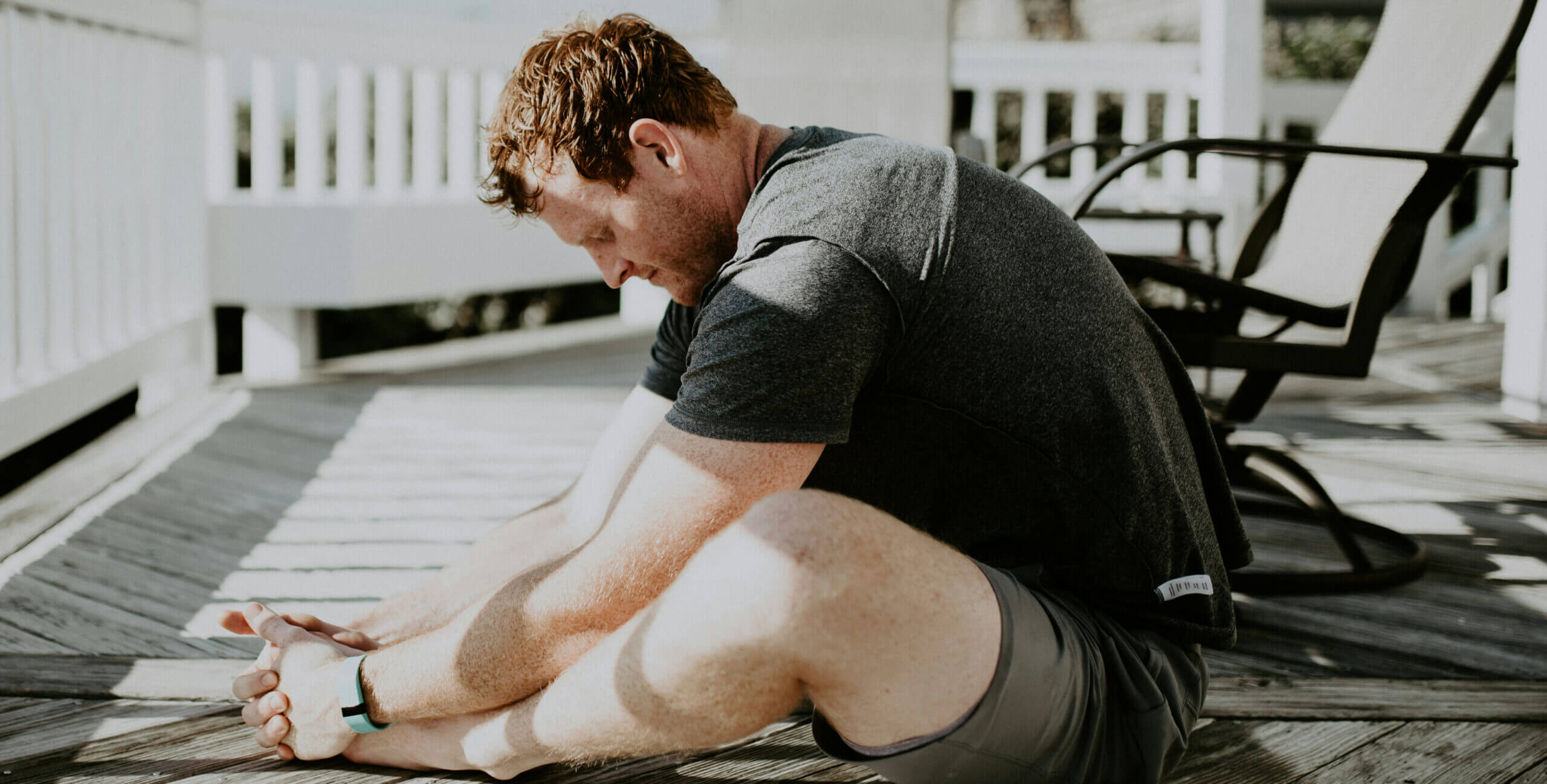 Man Stretching at Home on Porch
